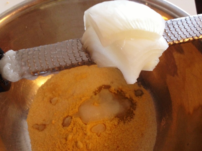 Dry ingredients and then use a microplane (or a grater if you don't have one) and grate your onion right in to the bowl.