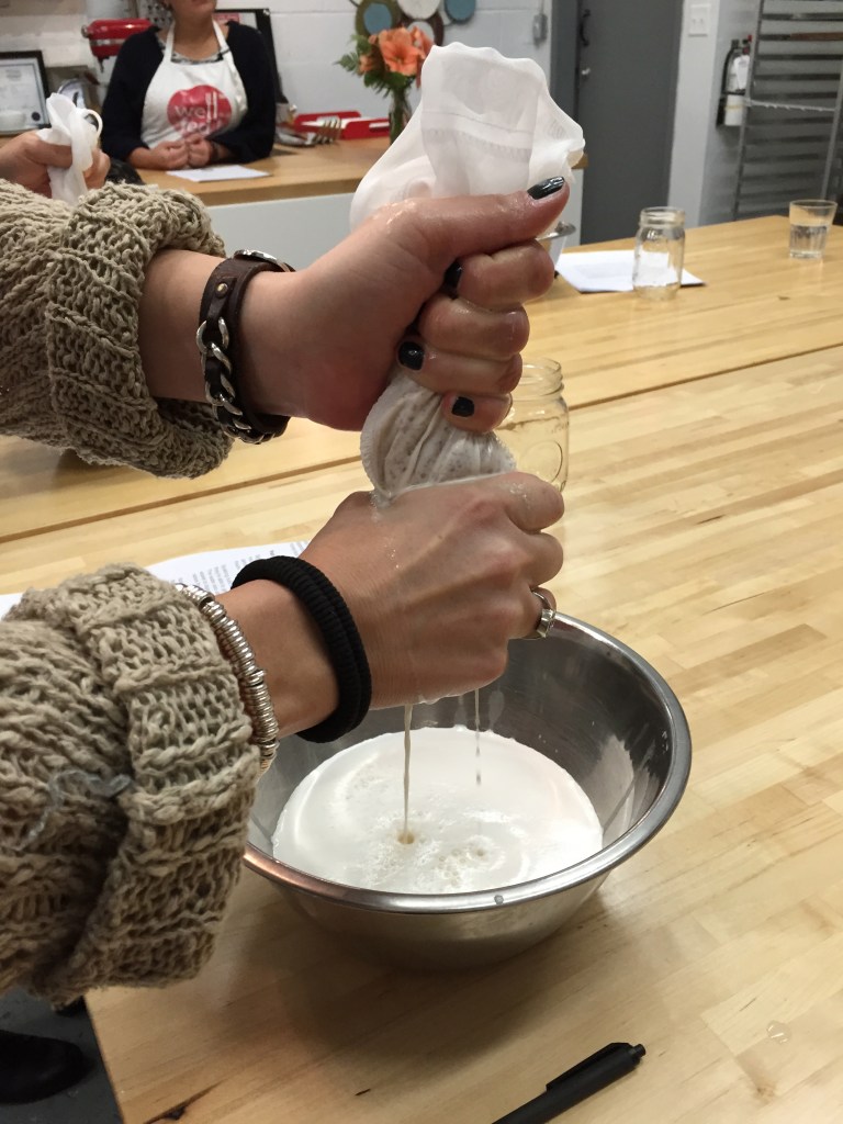 Squeezing through the nut mylk bag.